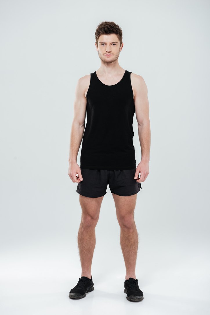 Before: Before and after AI preview of bigger arms and shoulders on a slim young man in a black tank top, made in Buldy